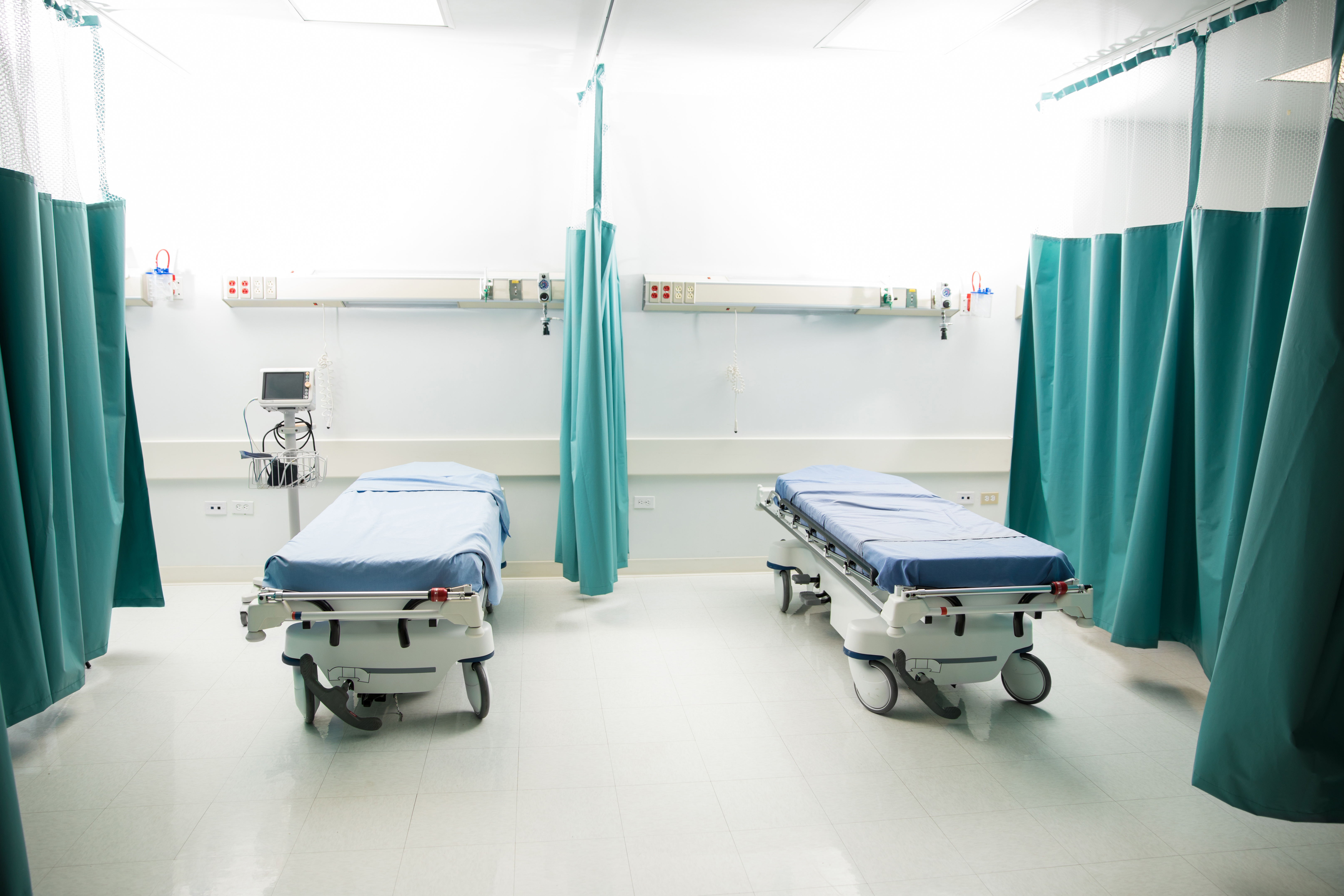 Empty hospital room with multiple beds